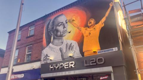 Mural on the wall of a shop of footballer Alex Greenwood