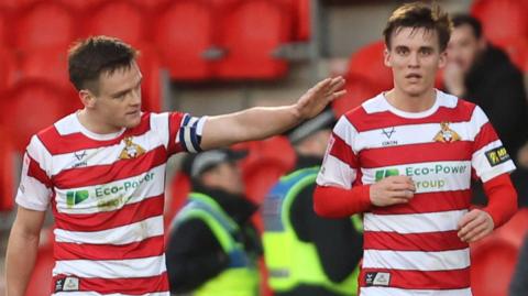 Doncaster players celebrate a goal