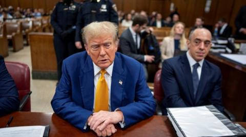 Trump sits next to defence lawyer Emil Bove
