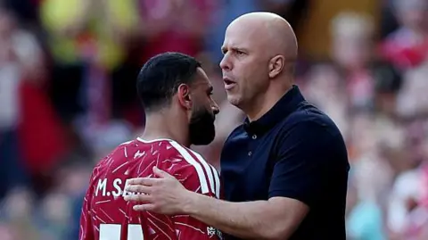 Arne Slot gives Mohamed Salah a pat on the back