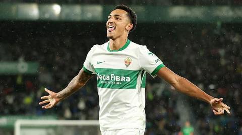 Alvaro Rodriguez celebrates a goal for Elche with his arms out wide
