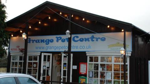 The shop front of The Grange Pet Centre in Botley. A white car is parked in front.
