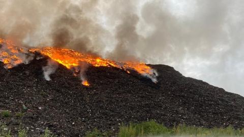 Fire at a landfill site causing huge plumes of smoke
