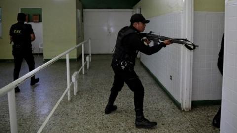 Police officers stand guard after suspected gang members attacked Roosevelt Hospital in Guatemala City, Guatemala August 16, 2017.
