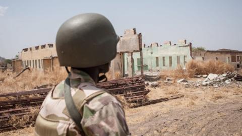 A soldier of the 7th Division of the Nigerian Army looking at the remaining dilapidated buildings of the Government Girls Secondary School Chibok in in Borno State north-eastern Nigeria on March 25, 2016.