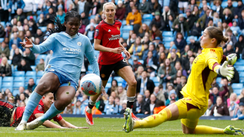 Khadija Shaw scores Manchester City's third goal against Manchester United in the Women's Super League