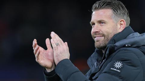 Luton Town boss Rob Edwards applauds fans after their win over Stoke City