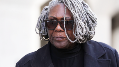 Janice Nix leaving the Old Bailey, wearing a black coat and sunglasses