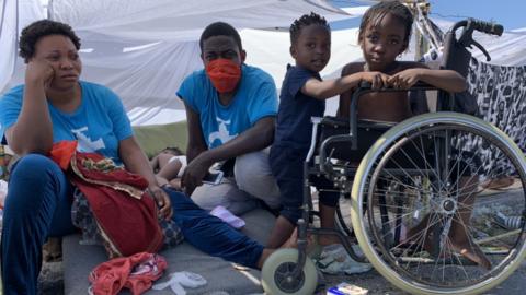 Scotti Kele (centre) and his family