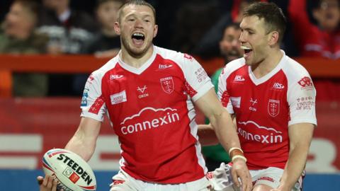 James Batchelor (left) celebrates a try for Hull KR