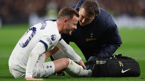 James Maddison of Tottenham Hotspur goes down with an injury