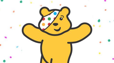 Pudsey bear logo on colourful background