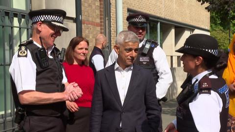 Sir Sadiq Khan and Met Commissioner Sir Mark Rowley speak with neighbourhood police officers during a visit in central London.