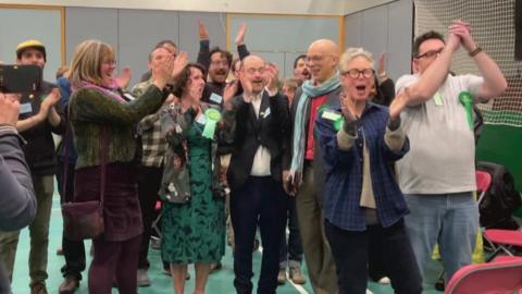 Green Party members celebrate at the Exeter local election count.