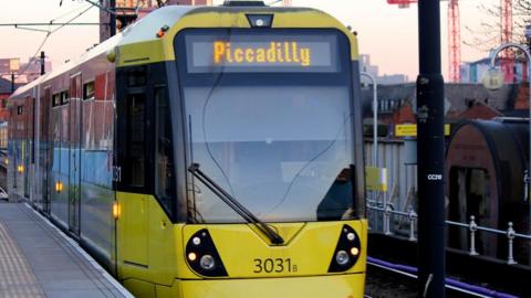 stock image of yellow tram with Piccadilly signage on the front 