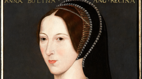 A portrait of Anne Boleyn where she is wearing black robes. She has a necklace on with the letter B as the pendant and her hands are visible holding a red rose.