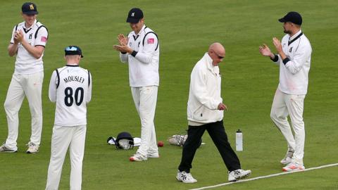 Players gave Jeff Evans a guard of honour during his final season as a professional umpire