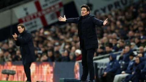 Keith Andrews throws his arms in the air