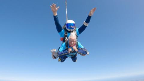 Manette Baillie and instructor skydiving