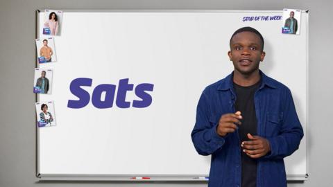 De-Graft in front of a white board that says Sats.