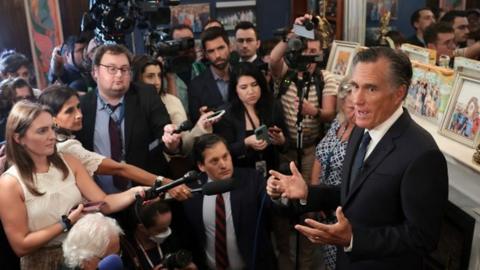 Mitt Romney talking to the press