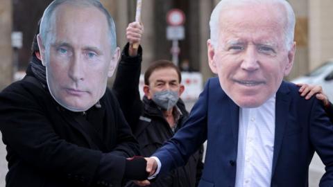 Anti-war protesters in Berlin don Biden and Putin masks