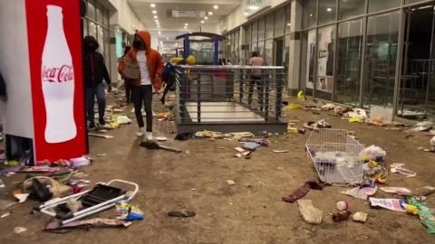 Debris strewn across the floor inside a shopping centre