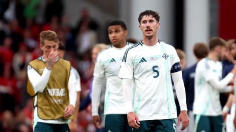 Northern Ireland players after their defeat in Denmark