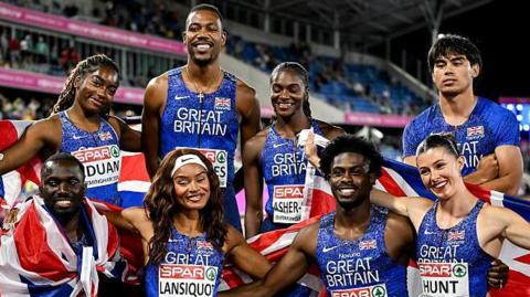 Great Britain's 4x100m relay teams pose for a picture after both won golds
