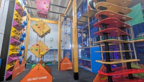 A multi-coloured climbing wall.