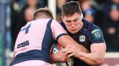Josh McNally (L) of Cardiff tackles Glasgow's Rory Darge