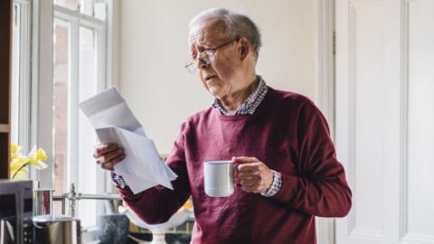 An old man worried over bills