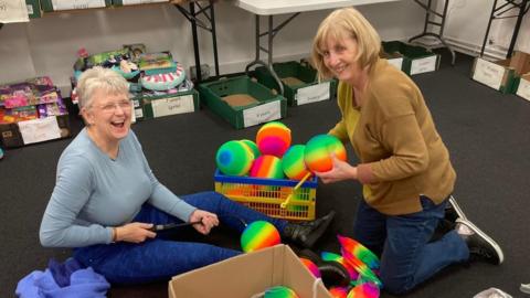 Volunteers wrapping presents for vulnerable children