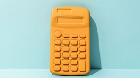 Yellow calculator on light blue background.
