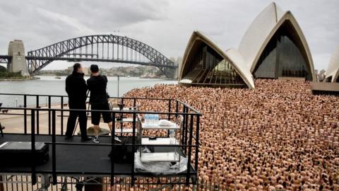 Spencer Tunick photographs a nude crowd in front of the Sydney Opera House in 2010
