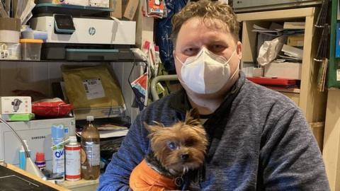 Mark Kelly and his support dog Gizmo - he now runs a mobile phone repair and accessory shop in Neath Market.