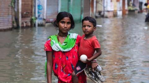 Girl and children standing in flooding in Bangladesh