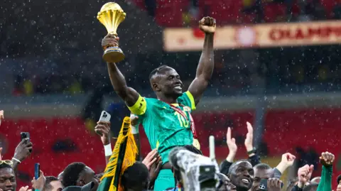 Sadio Mane lifts the Afcon trophy