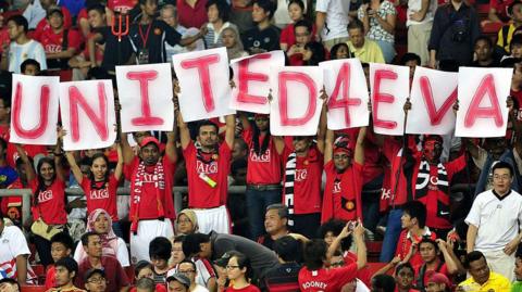 Manchester United fans in Malaysia hold up a banner showing 'United 4 Eva'