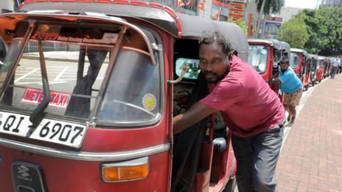 Sri Lankan three-wheelers wait in long queues for petrol at a fuel filling station in Colombo, Sri Lanka on May 16, 2022.