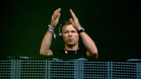 Pete Tong on-stage at 2014 DJ event, clapping