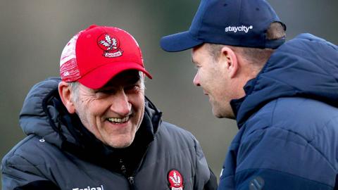 Derry boss Mickey Harte shares a smile with Dublin manager Dessie Farrell before the game