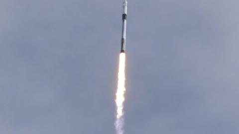 A SpaceX Falcon 9 rocket, carrying the Crew Dragon astronaut capsule