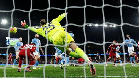 Virgil van Dijk of Liverpool scores past Gianluigi Donnarumma of Manchester City but the effort is ruled out for offside against Andrew Robertson