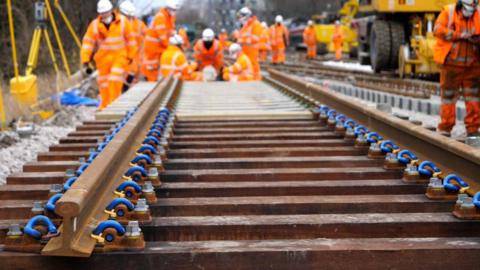 Workers doing upgrade work on a rail track
