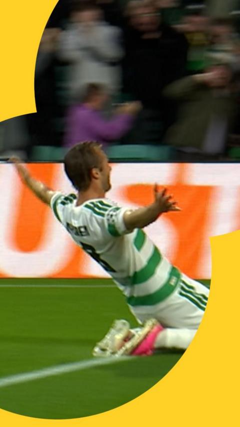 Benjamin Nygren slides on his knees with his arms stretched out after scoring for Celtic