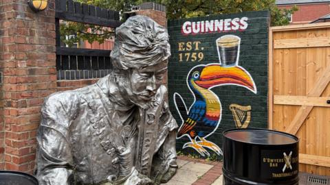 A large fibreglass statue of a sultan in a pub beer garden.