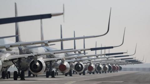 Passenger planes parked on a runway on 26 May