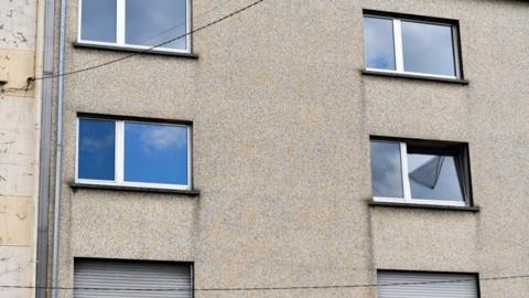 A photograph shows two windows (C) of the flat of a couple in Forbach, eastern France, on August 7, 2023, after French police said they had arrested a 55-year-old German national who is accused of holding his 53-year-old wife captive in a flat since 2011.