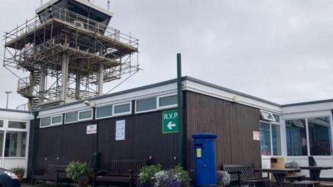 A view of Alderney Airport arrivals including the tower. 